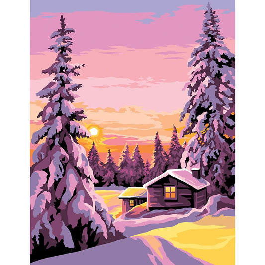 I pini e le case innevate al tramonto